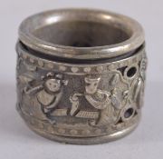 A CHINESE SILVER PLATE ARCHERS RING.