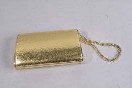A JIMMY CHOO GOLD CLUTCH EVENING BAG on a chain, with dust bag. 5.75ins x 3.5ins.