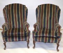A GOOD PAIR OF WING ARMCHAIRS, striped fabric, on cabriole legs.