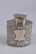A VICTORIAN SILVER OVAL TEA CADDY with repousse decoration. London 1895.