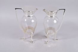 A GOOD PAIR OF LARGE CHRISTOPHER DRESSER DESIGN GLASS AND PLATE CLARET JUG. 10ins high.