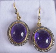 A PAIR OF SILVER GILT OVAL CABOCHON AMETHYST AND DIAMOND HALO DROP EARRINGS, boxed. Amethysts 2.7ct,
