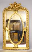 A LARGE LOUIS XVI STYLE GILTWOOD MIRROR, the top with cupids and oval panel. 5ft 10ins high x 3ft