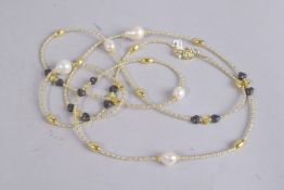 A STERLING SILVER GILDED AND PEARL LONG CHAIN.