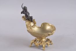 A GOOD GILT BRONZE CUPID SALT. 7ins high.