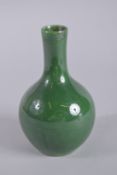 A CHINESE GREEN GROUND VASE. 6ins high.