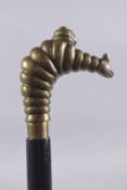 A BRONZE MICHELIN MAN WALKING STICK. 38ins long.