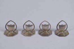 A SET OF FOUR SILVER SHIELD SHAPED MENU HOLDERS in box. Birmingham 1910.