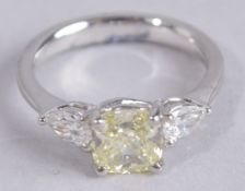 A SUPERB 1.5CT YELLOW DIAMOND RING with diamond shoulders.