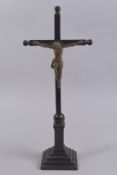 A 16TH-17TH CENTURY CRUCIFIX on a wooden base. 17.5ins high.