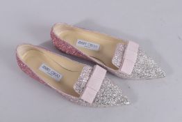A PAIR OF JIMMY CHOO PINK GLITTER SHOES, size 38. Signs of wear. 339.