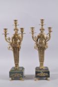 A GOOD PAIR OF EMPIRE DESIGN METAL THREE-LIGHT CANDELABRA on square marble base. 18ins high.