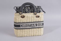 A CHRISTIAN DIOR HESSIAN BAG, liner and strap. 8ins high.