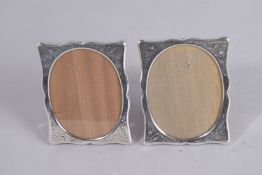 A PAIR OF SILVER PHOTOGRAPH FRAMES. 5.5ins x 6ins.
