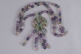 A TRIPLE ROW MIXED STONE NECKLACE AND CIRCULAR PENDANT.