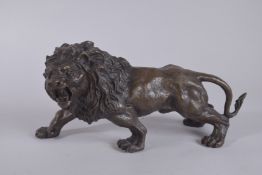 A BRONZE LION. 11ins long.
