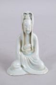 A CHINESE CELADON GLAZE POTTERY FIGURE of seated Guanyin. 15cm high.