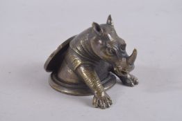 A BRONZE RHINO CIRCULAR DESK WEIGHT.