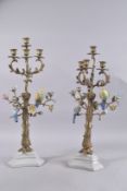 A GOOD PAIR OF GILT METAL AND PORCELAIN BIRD FOUR-BRANCH CANDELABRA. 23ins high.