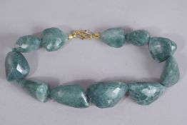 A BLUE JOHN TYPE NECKLACE set with eleven stones. 19ins long.