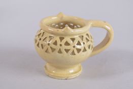 A POTTERY PUZZLE JUG.