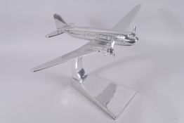 A LARGE CHROME DAKOTA PLANE.