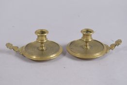 A SMALL PAIR OF CIRCULAR BRASS CHAMBER CANDLESTICKS. 3.75ins diameter.