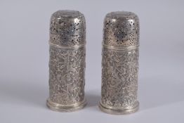 A PAIR OF SCOTTISH SILVER DRUM SUGAR SIFTERS with repousse decoration. 6ins high. Edinburgh 1886.