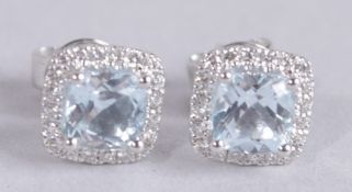 A PAIR OF 18CT WHITE GOLD, BLUE TOPAZ AND DIAMOND STUDS.
