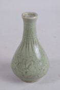 A CHINESE CELADON GLAZE POTTERY VASE. 15.5cm high.