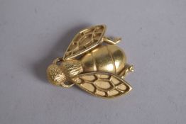 CHRISTIAN DIOR. A GILT METAL BEE BROOCH, signed.