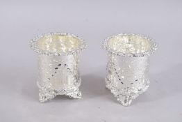 A PAIR OF PIERCED PLATED BOTTLE COASTERS.