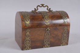 A BRASS BOUND WALNUT CASKET. 9ins high.