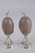 A GOOD PAIR OF SILVER PLATE MOUNTED EMU EGGS. 10ins high.