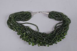 A DELICATE GREEN MULTI ROW NECKLACE.