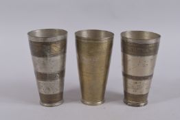 THREE ENGRAVED METAL MARRIAGE CUPS. 7ins.