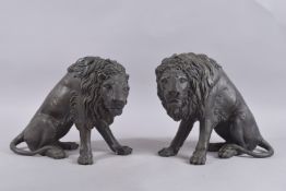 A PAIR OF BRONZE LIONS. 10ins high.