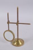A MAGNIFYING GLASS on a stand.