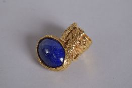 AN YVES ST. LAURENT GILT METAL AND BLUE STONE NECK TIE in original box.