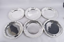 A SET OF SIX PLATES with gadrooned edges. 12ins diameter.