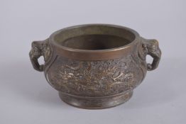 A CHINESE BRONZE CIRCULAR CENSER with elephant handles. 4ins diameter.