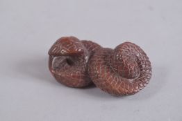 A JAPANESE CARVED SNAKE NETSUKE, signed. 2ins.