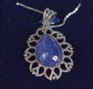 A PEAR SHAPED CABOCHON TANZANITE AND DIAMOND PENDANT in silver on a silver chain, boxed Tanzanite
