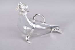 A LARGE PLAIN GLASS NOVELTY DECANTER with walrus head. 15ins high.