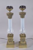A PAIR OF CORINTHIAN COLUMN METAL AND GLASS LAMPS. 20ins high.