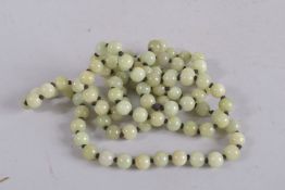 A STRING OF CELADON BEADS. 50ins long.