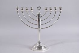 A SILVER MENORAH. 11ins high.