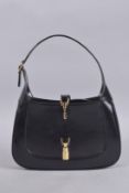 A GUCCI BLACK PATENT HANDBAG. 11ins wide.