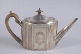 A GEORGE III SILVER OVAL TEAPOT, fluted sides with wooden handle and finial. London 1798.