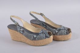 A PAIR OF JIMMY CHOO FLAT FABRIC SHOES, size 38.5. Signs of wear.